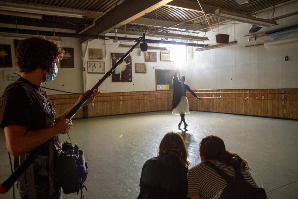 Madame Olga dances in a ballet studio, as a camera crew films her.