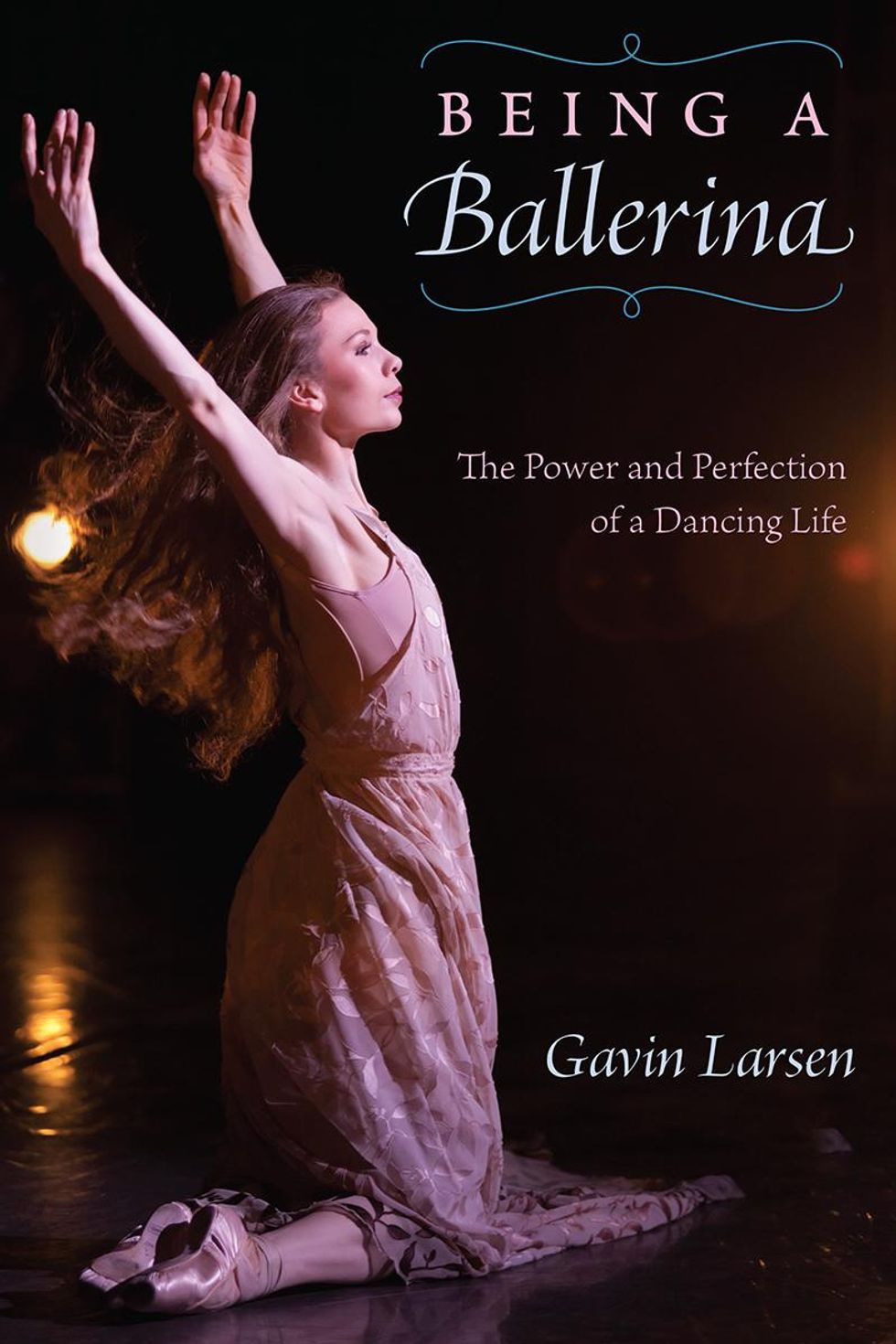 A book cover shows a photograph of Gavin Larsen on her knees onstage in a pink dress, lifting her arms high above her. To the upper right are the words Being a Ballerina: The Power and Perfection of a Dancing Life, and on the lower right the author's name, Gavin Larsen.