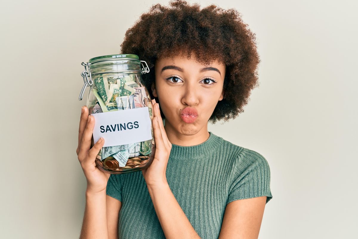 woman holding savings jar