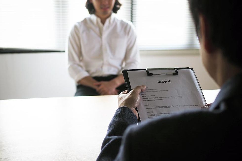 Hiring manager reviews a job candidate's resume during an interview