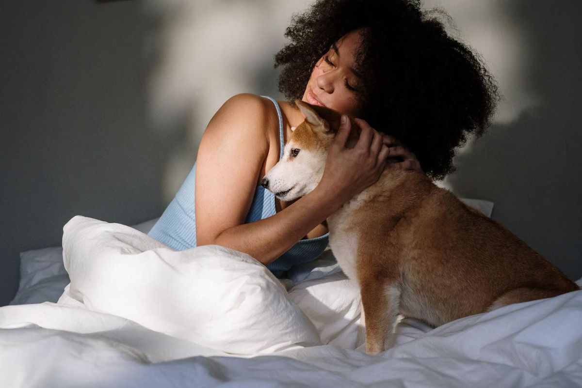 Woman in bed with her dog