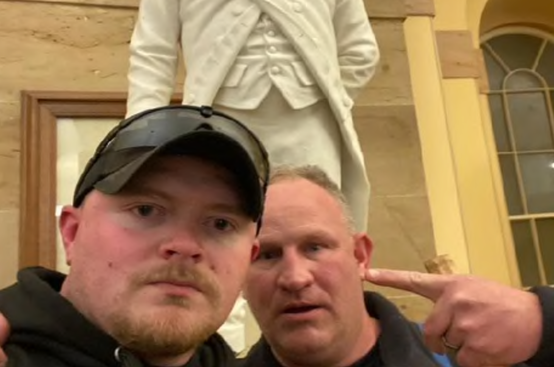 Thomas Robertson, right,  and Jacob Fracker during the January 6, 2021 Capitol insurrection. 