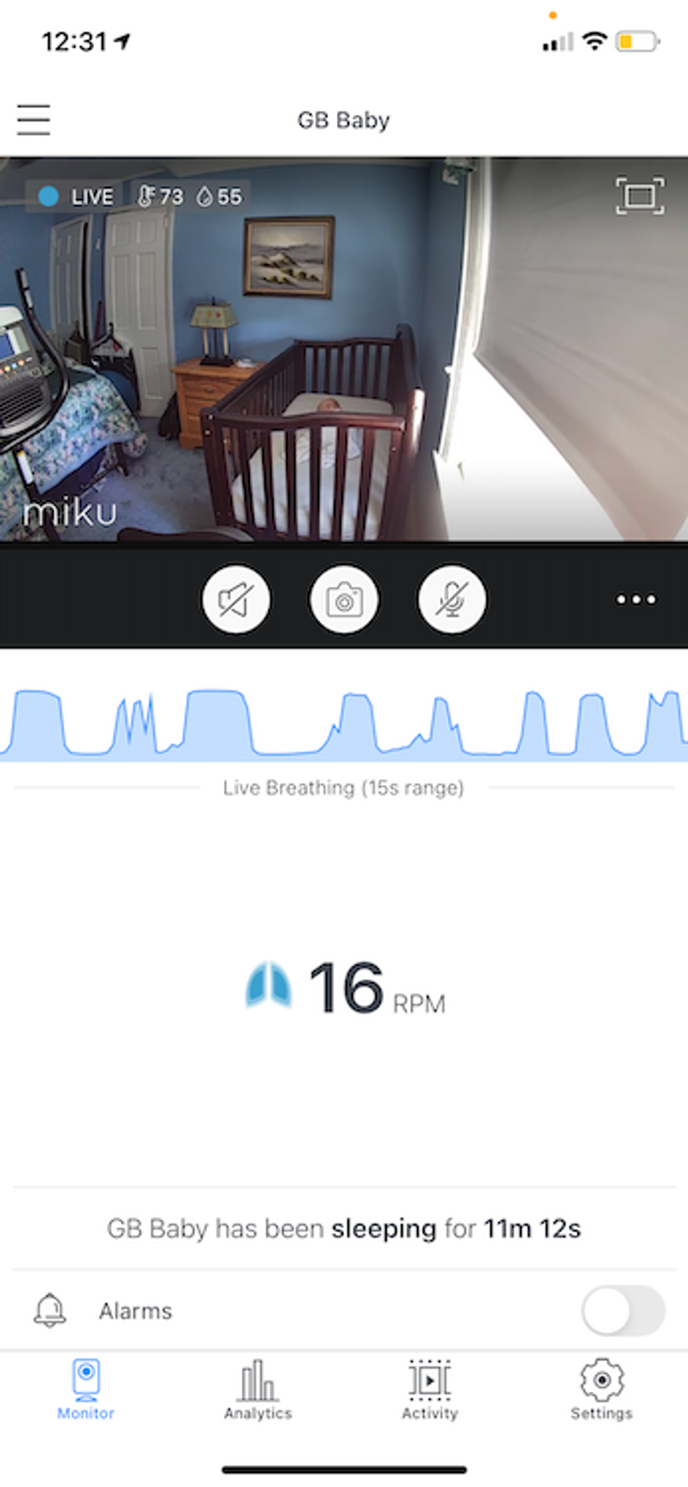 baby sleeping in crib with Miku app tracking breathing.