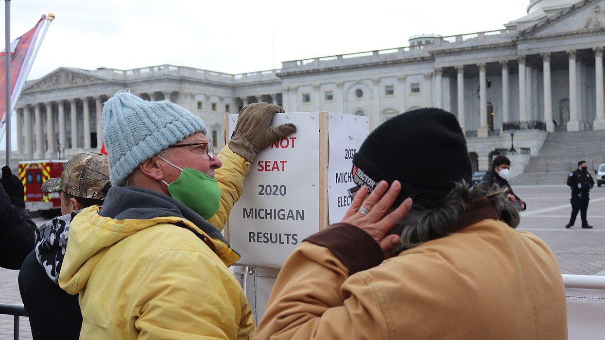 Man protests Michigan's election results on the day of the January 6 Capitol insurrection.