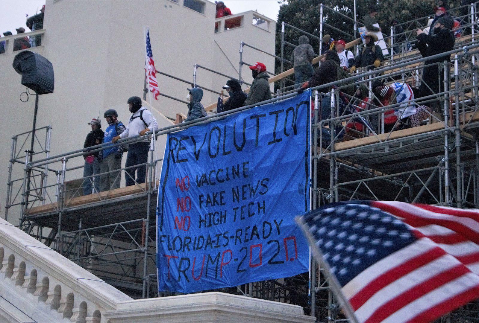Banner protesting vaccines at the January 6 Capitol insurrection. 