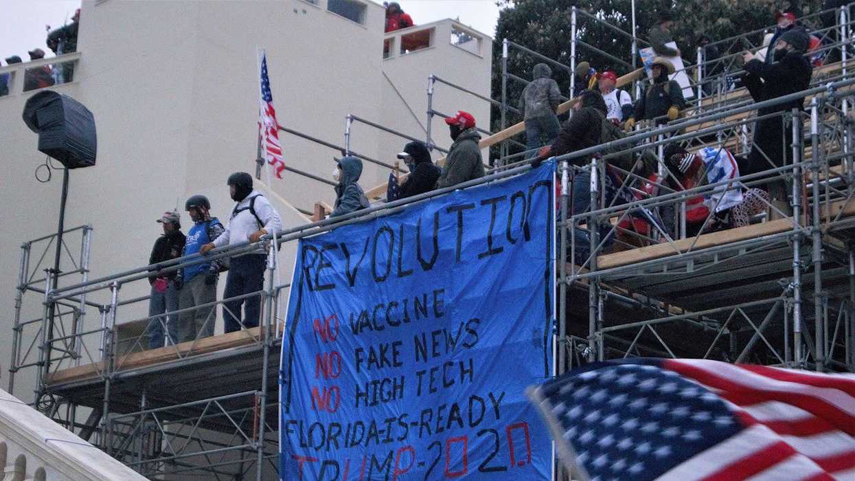 Banner protesting vaccines at the January 6 Capitol insurrection.