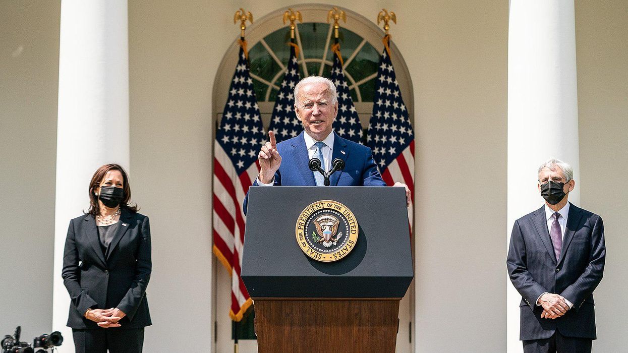 President Biden speaking, with Attorney General Merrick Garland, right, and Vice President Harris.