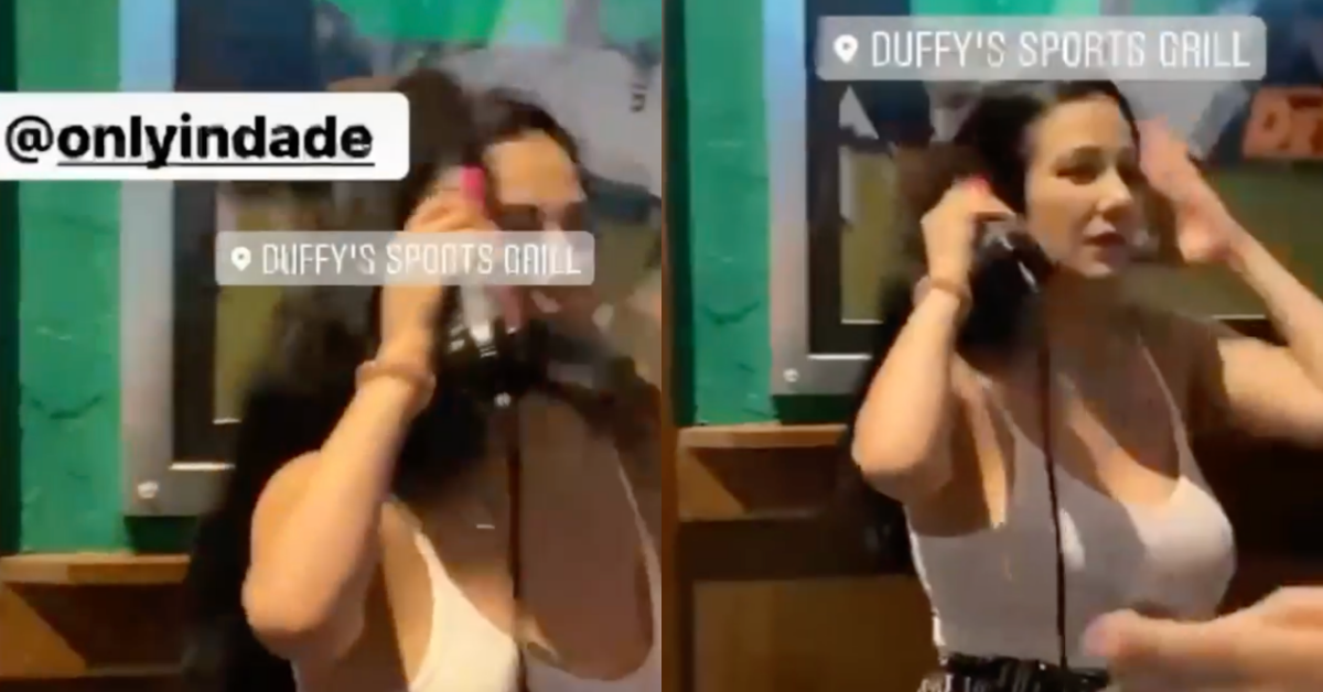 Woman Becomes Instant Icon After She's Filmed Styling Her Hair At A Crowded Sports Bar