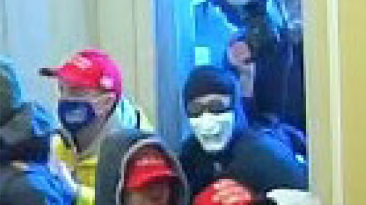 Fi Duong in a white mask at the January 6, 2021 Capitol insurrection.