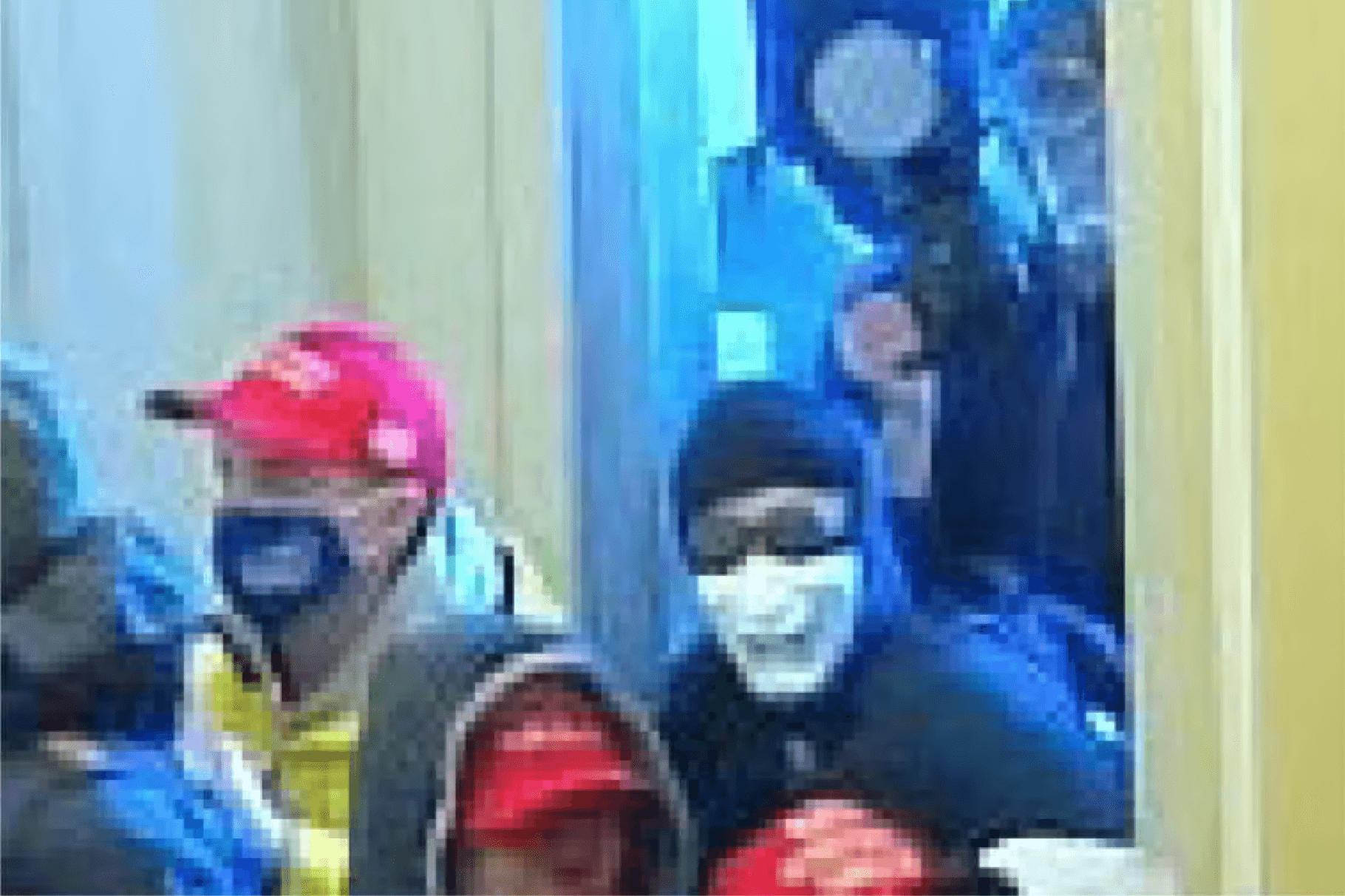 Fi Duong in a white mask at the January 6, 2021 Capitol insurrection. 