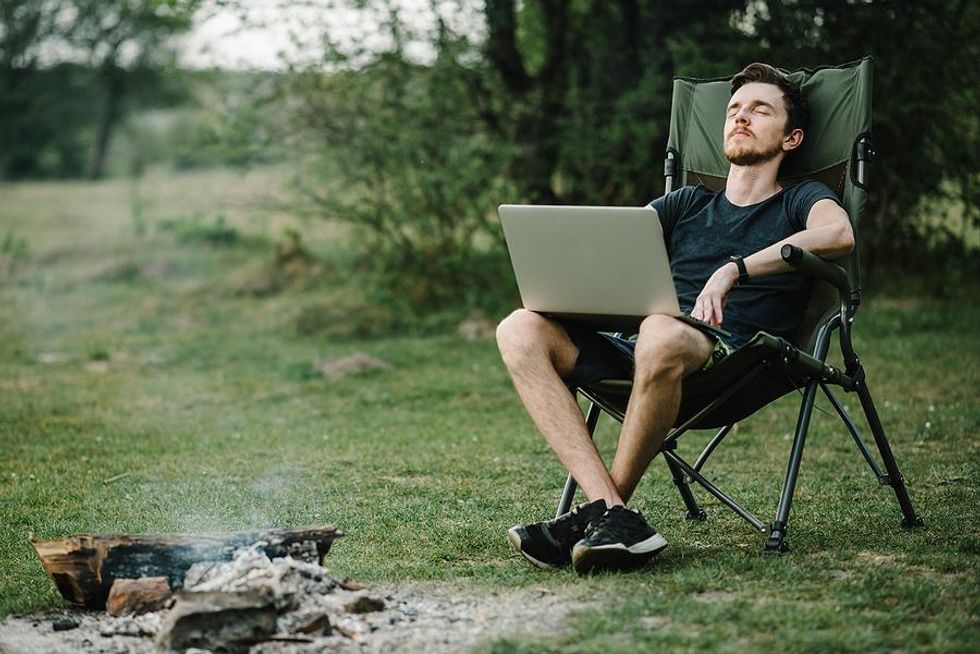 Man works while camping in the summer