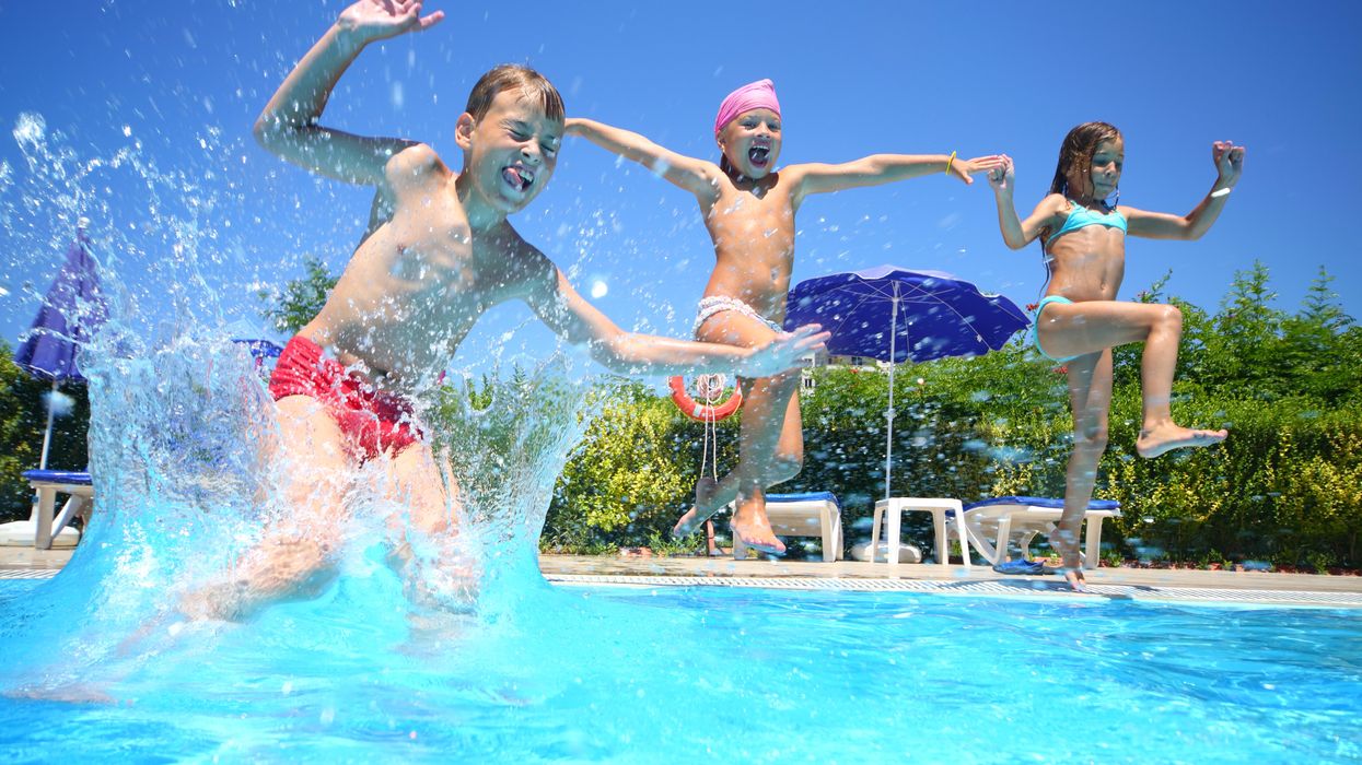 Three kids jumping in pool