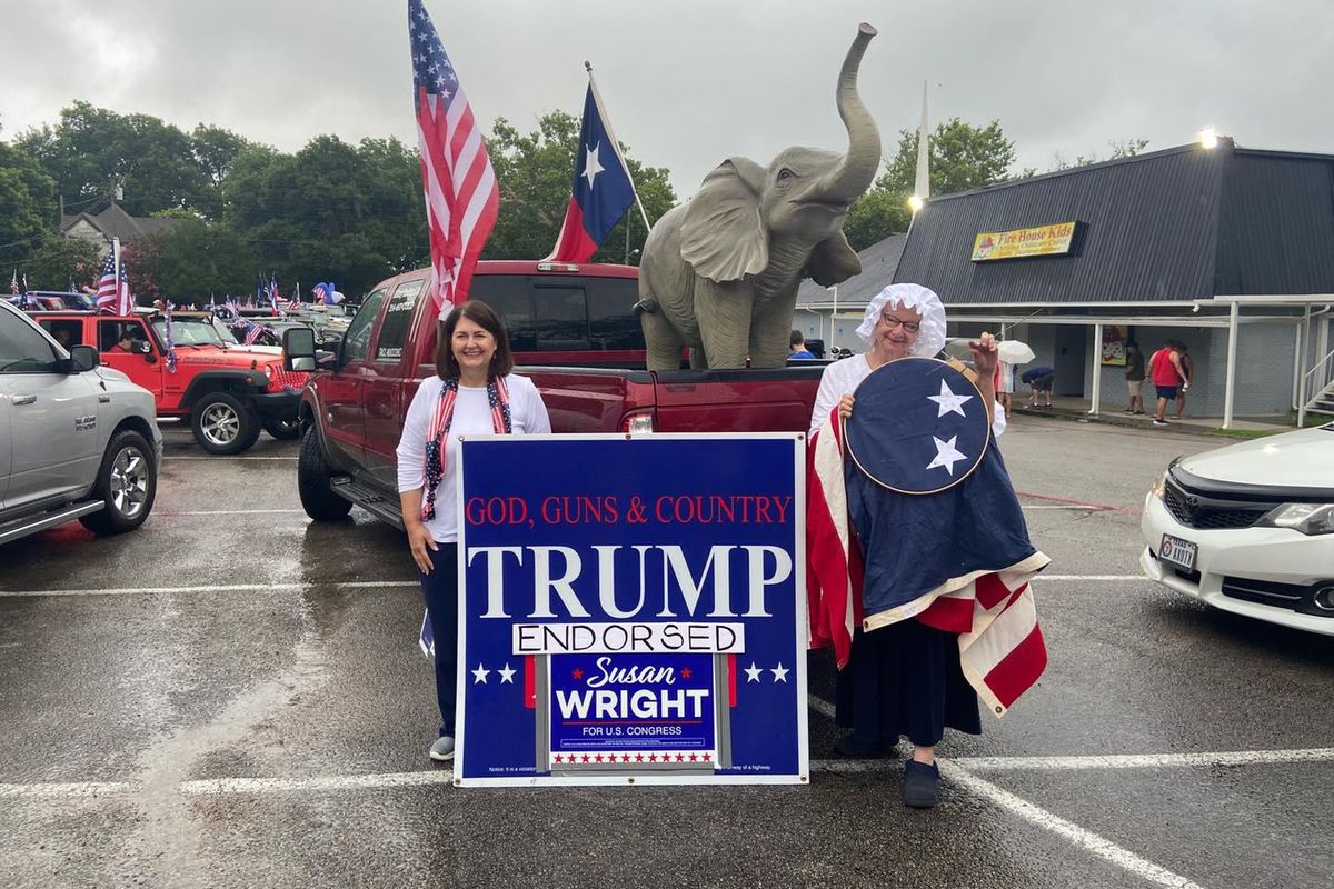 Susan Wright, left, poses next to a "Trump endorsed" campaign sign.