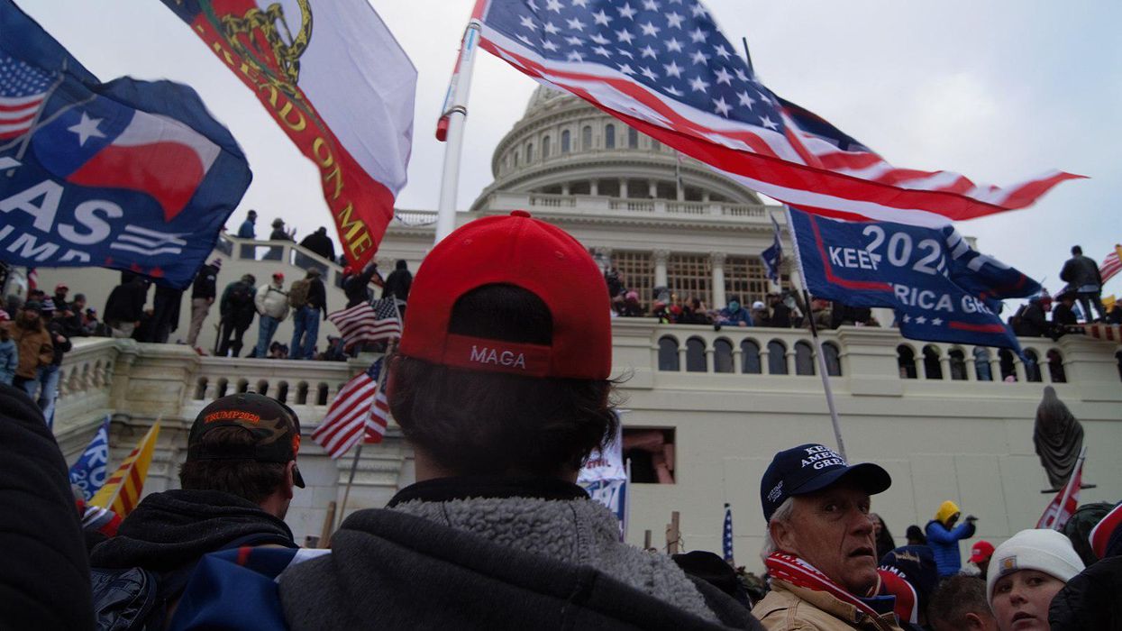 Man wears "MAGA" hat at the January 6, 2021 Capitol insurrection.