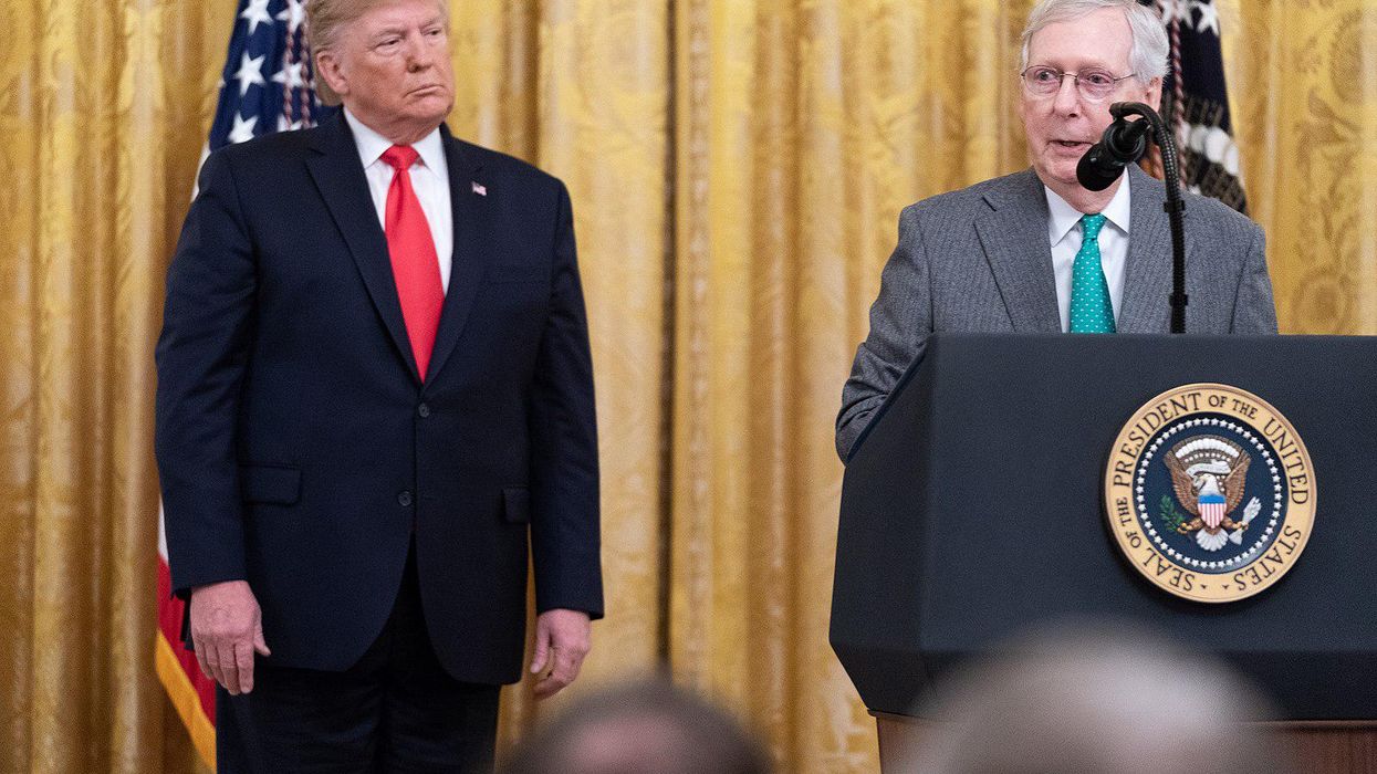 Former President Trump, left, watches Sen. Mitch McConnell speak in 2019.