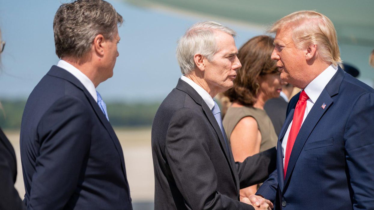 Sen. Rob Portman, center, shakes hands with former President Trump