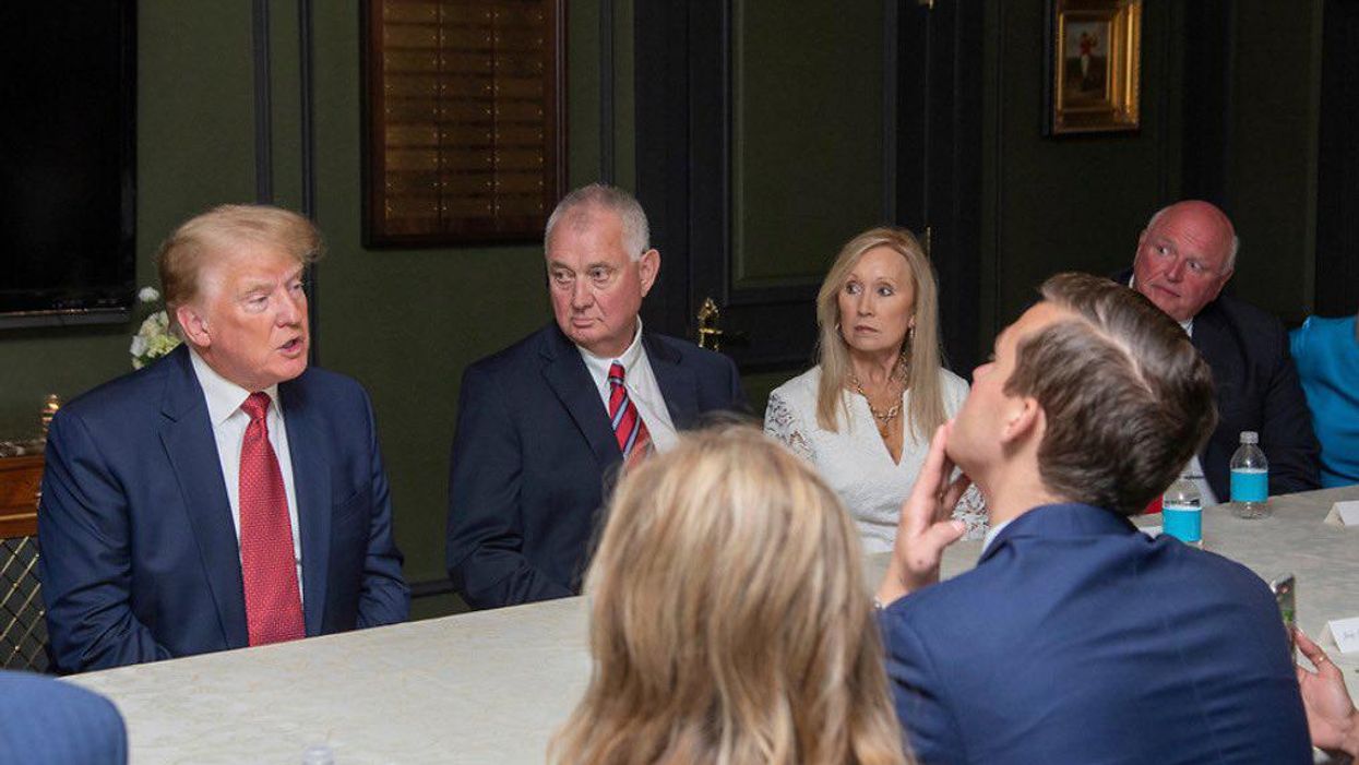 Rep. Madison Cawthorn, right, listens to former President Trump at a fundraising dinner.