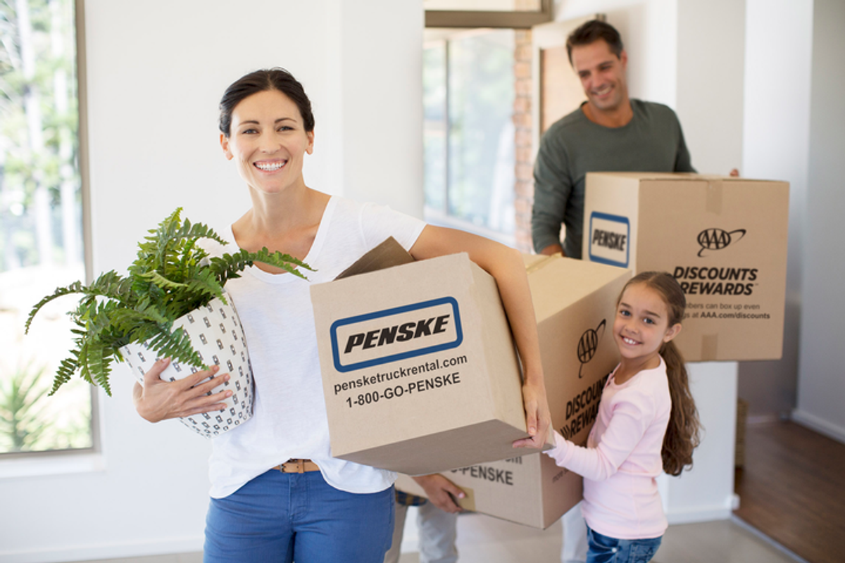 family carrying moving boxes