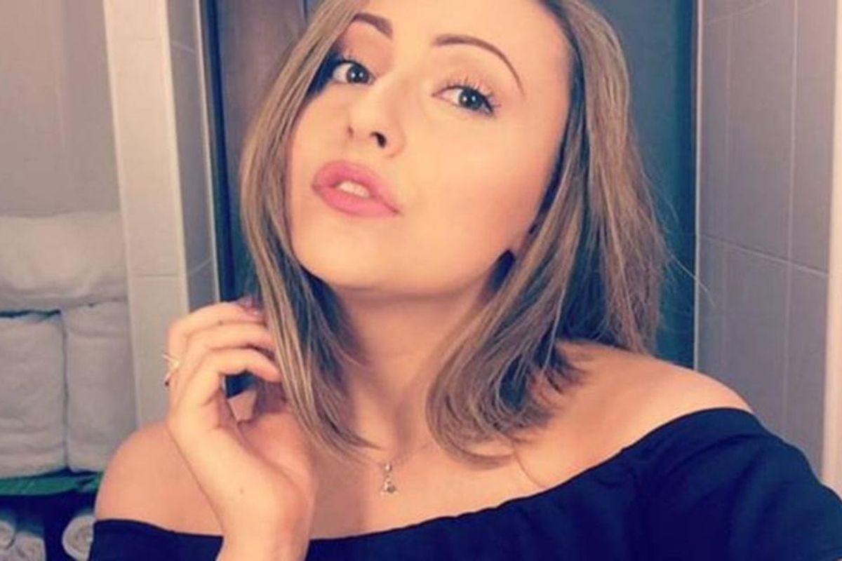 A woman poses in the mirror