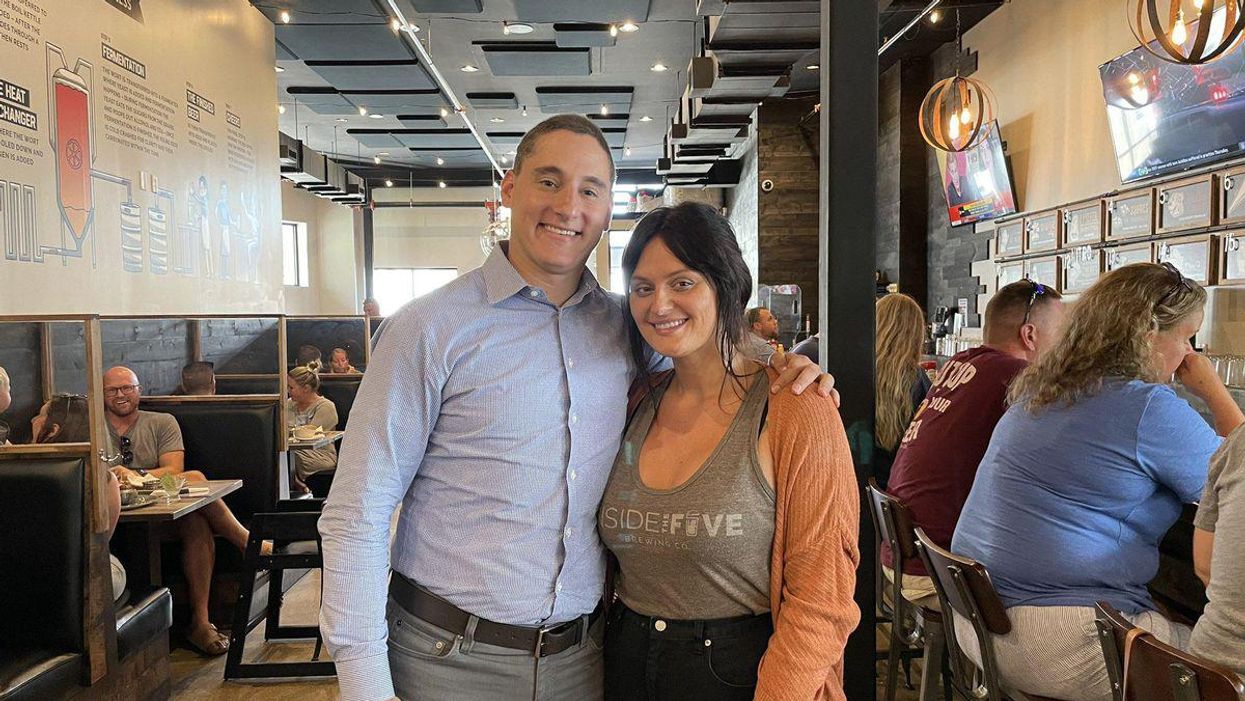 Josh Mandel, left, poses for a picture with a sick waitresses at an Ohio brewery.