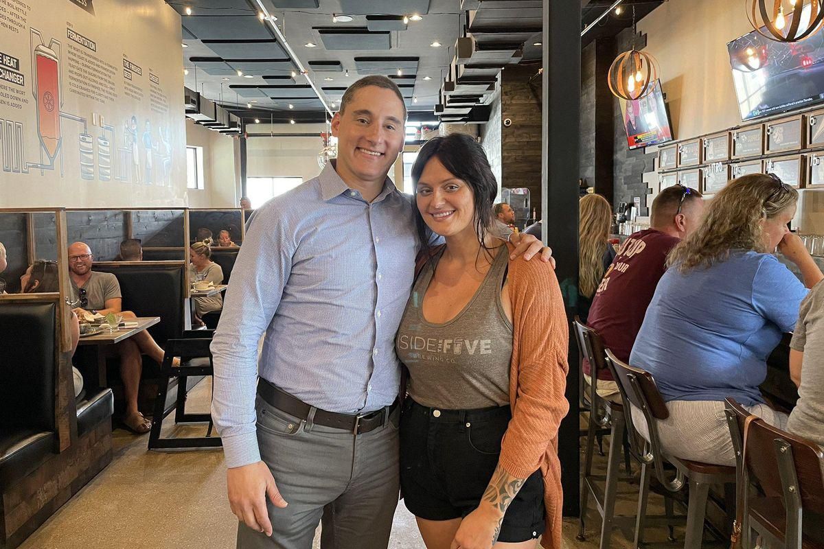Josh Mandel, left, poses for a picture with a sick waitresses at an Ohio brewery.