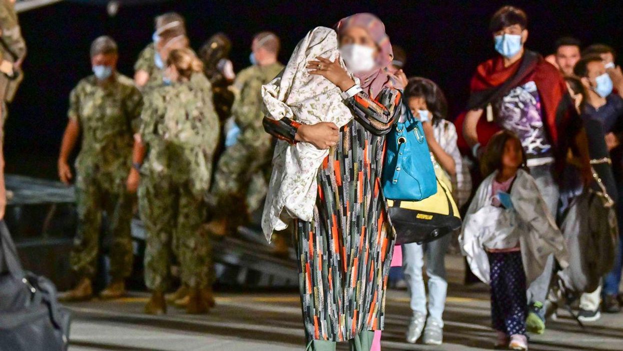 Afghan evacuees arriving at a US Military base. 