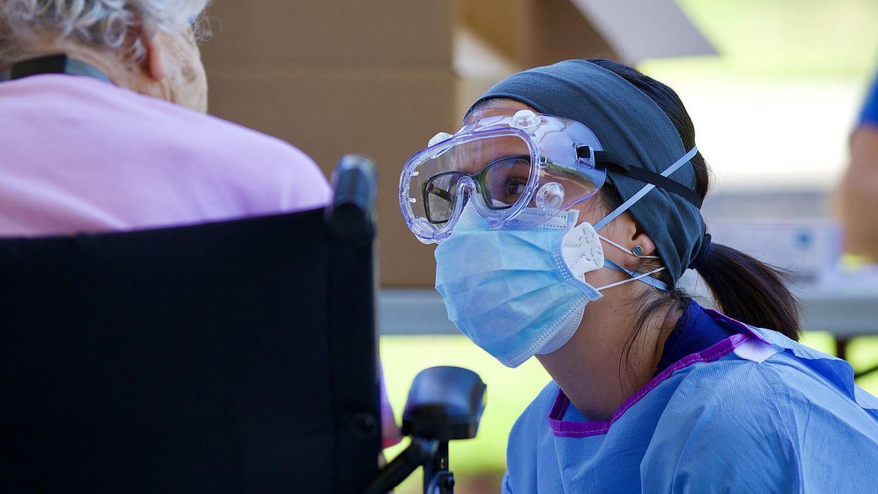 Florida nurse prepares patient for COVID test.