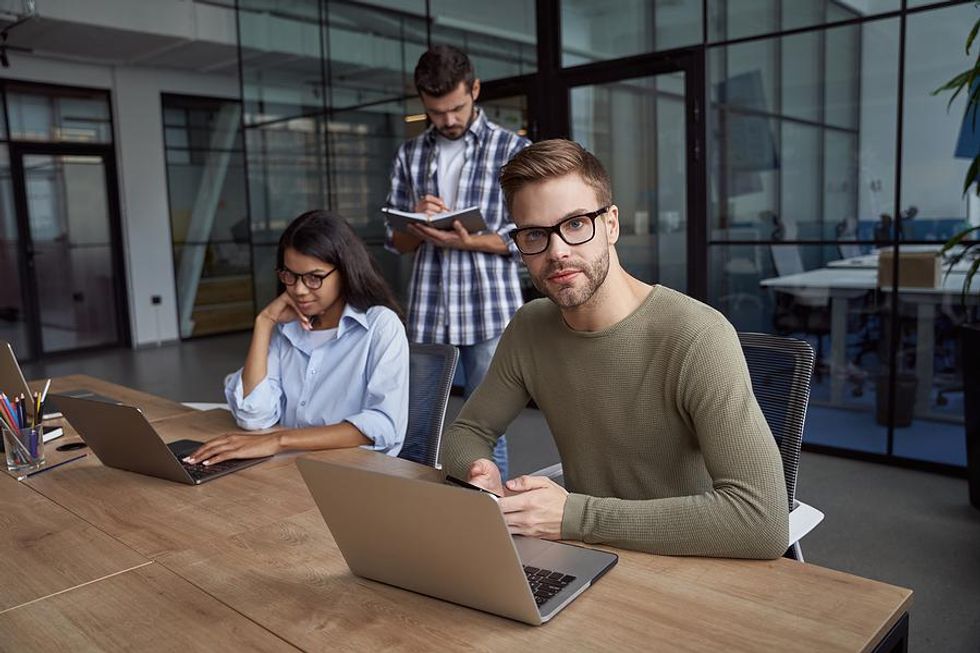 Man works with colleagues at his new job