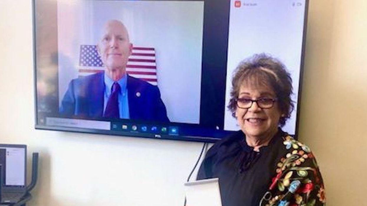 Sen. Rick Scott, left, congratulates Maria Weese.