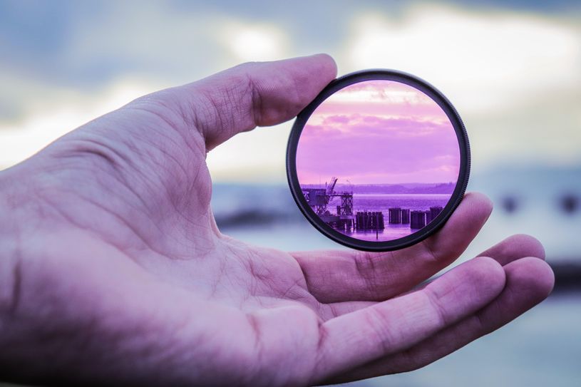 hand holding pink lens