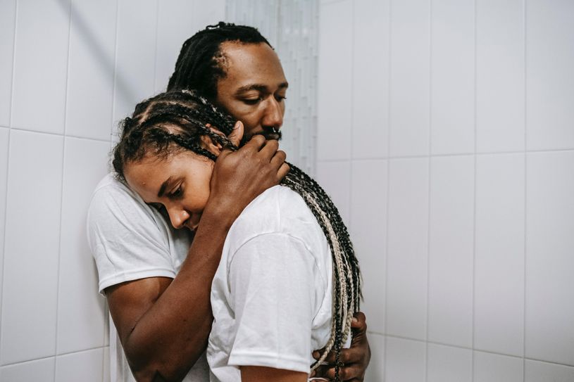 man and woman hug in the shower