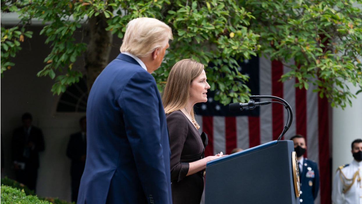 Justice Amy Coney Barrett speaks next to former President Trump, left.