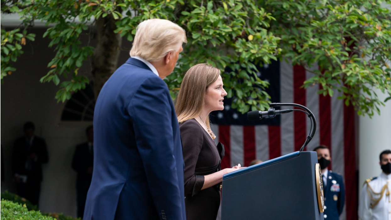 Justice Amy Coney Barrett speaks next to former President Trump, left. 