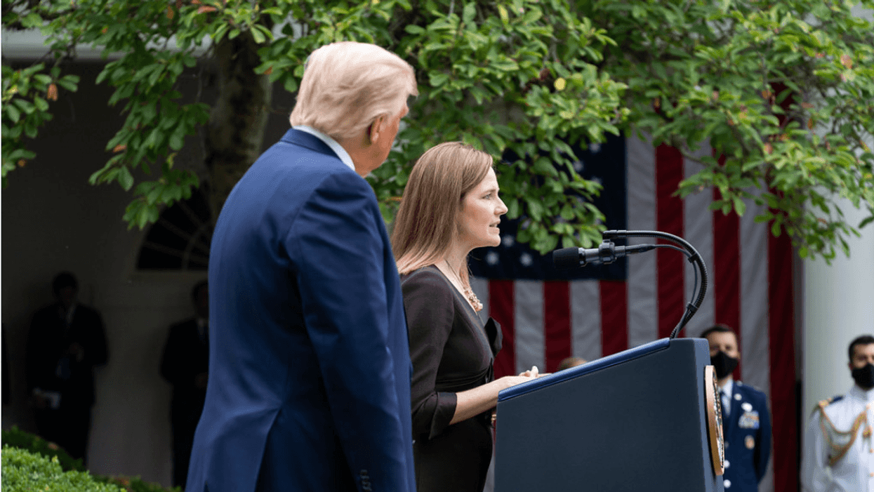 Justice Amy Coney Barrett speaks next to former President Trump, left.