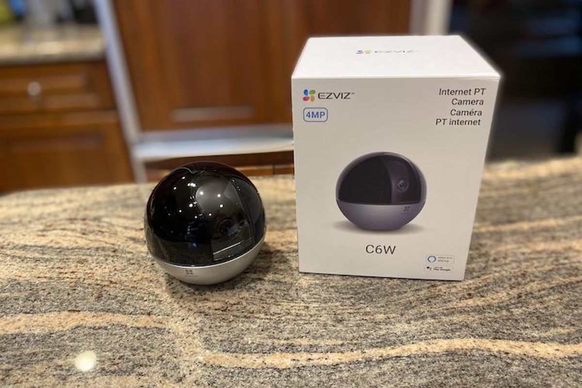 EZVIZ C6W Pan and Tilt camera and box on a counterop