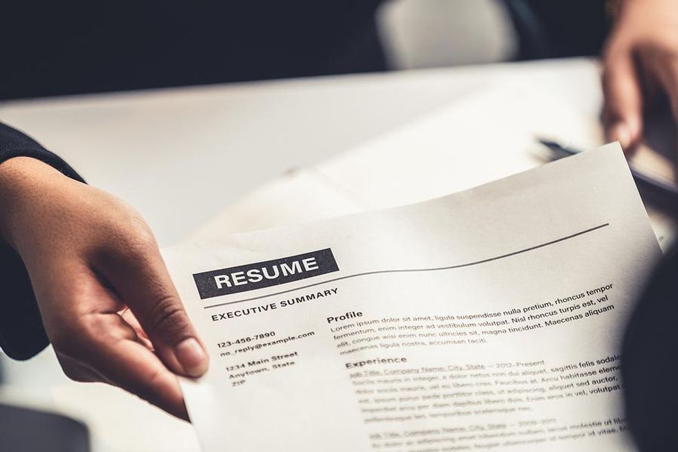 Job candidate gives the hiring manager their resume