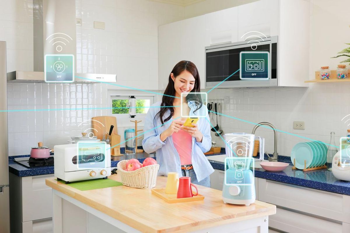 Woman controlling here smart appliances in her smart home.