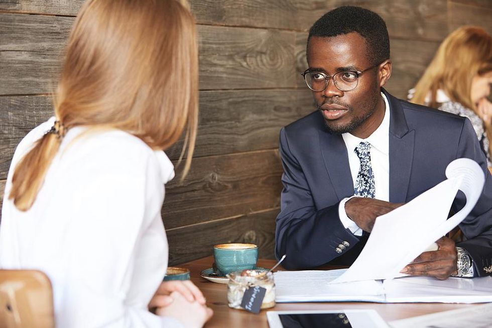 Woman listens to her manager during a performance review