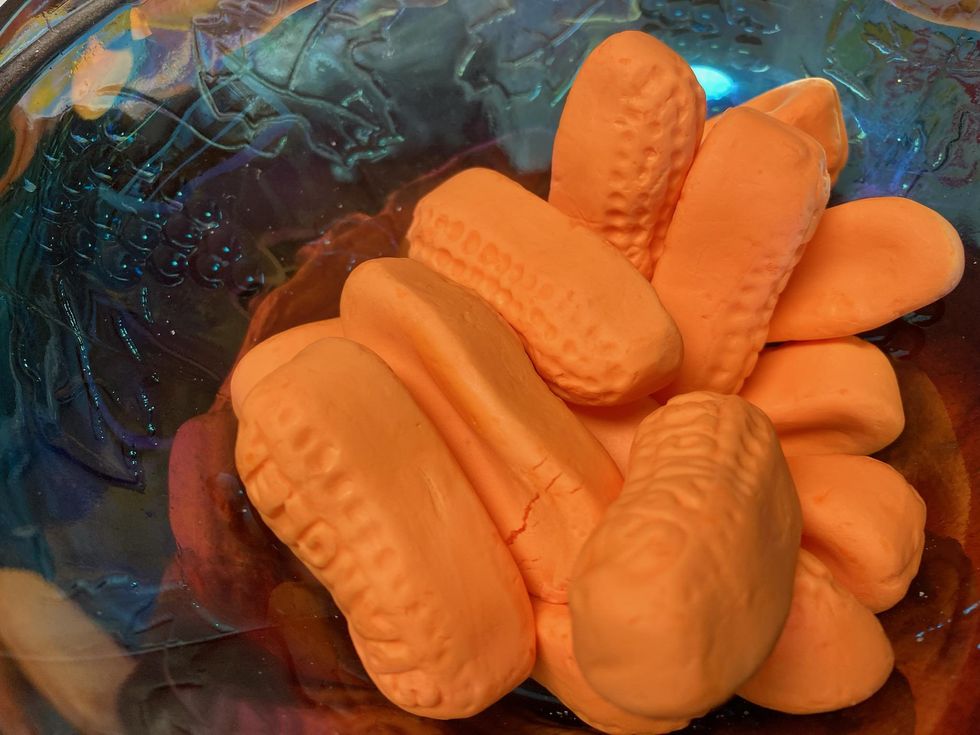 Circus peanuts in a blue dish.