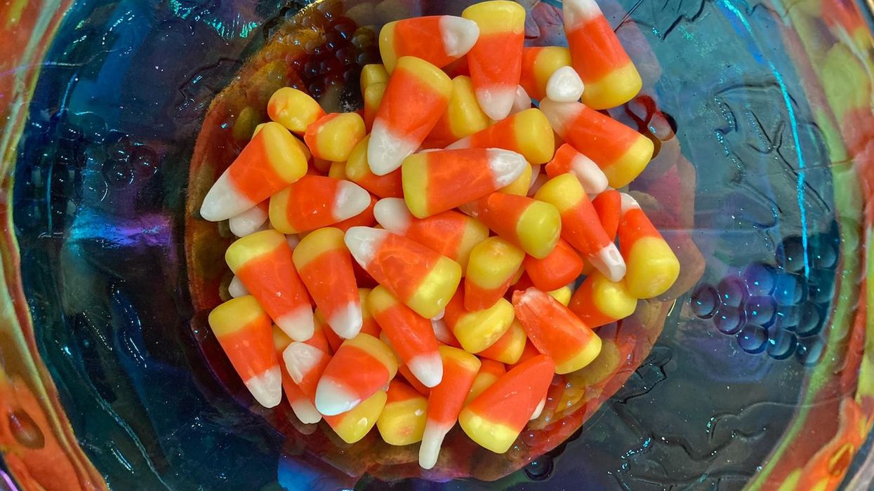 Candy corn in blue bowl.