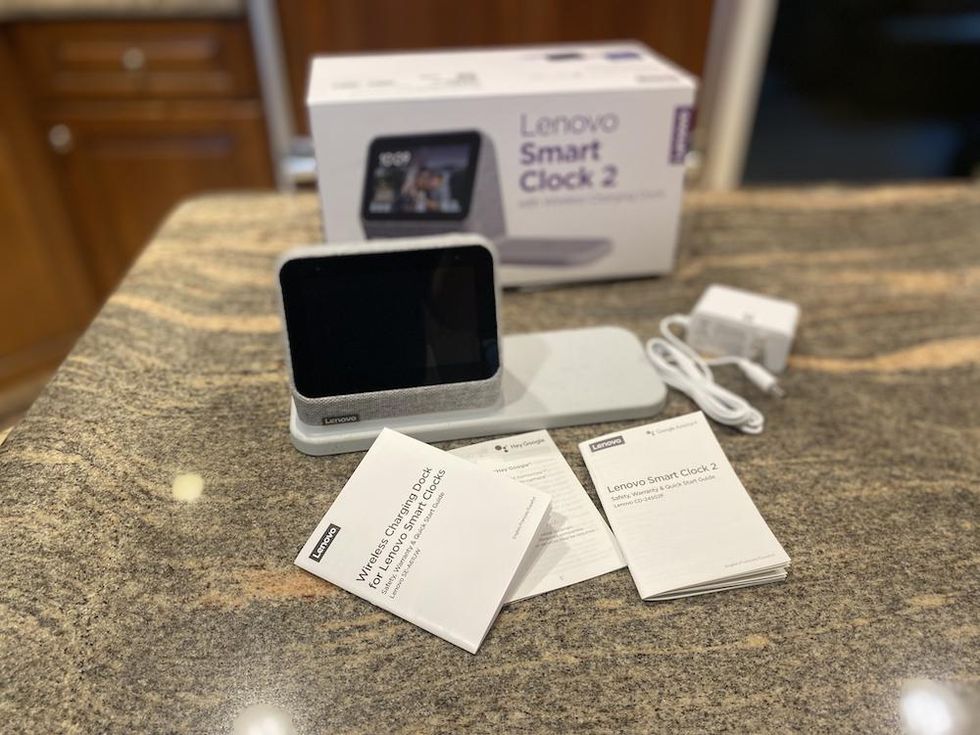 Lenovo Smart Clock 2 unboxed on a counter.