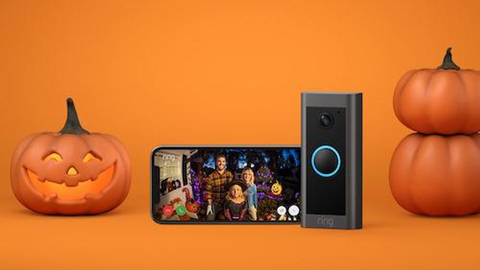 Ring Video Doorbell and smartphone with halloween decorations