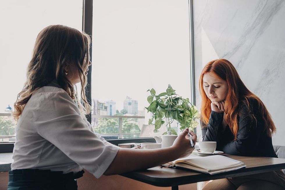 Woman feeling burned out in a meeting