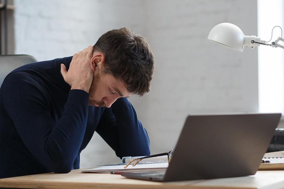 Man feeling burned out at work