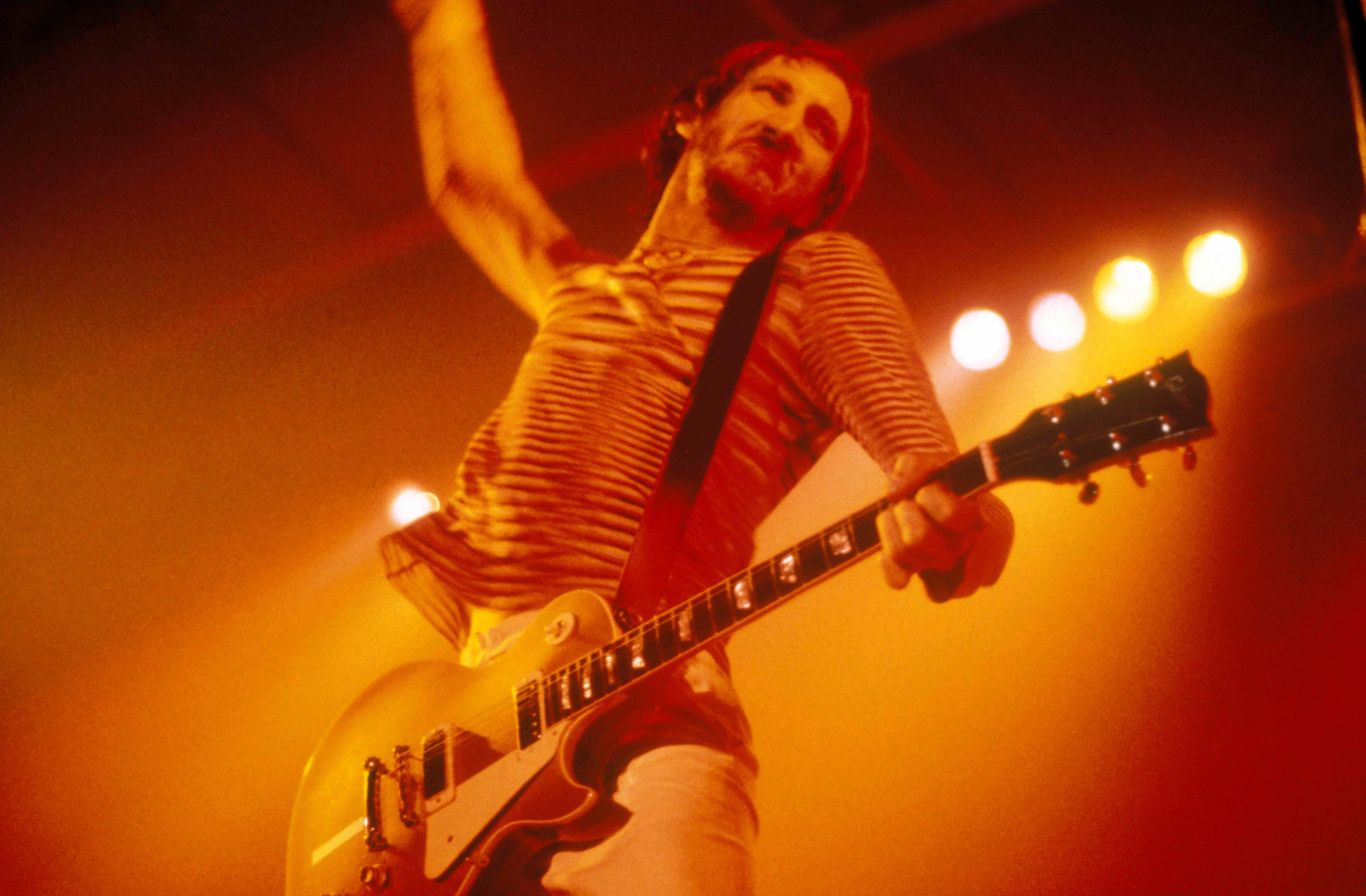 Pete Townshend with playing a Gibson Les Paul guitar doing windmill arm
