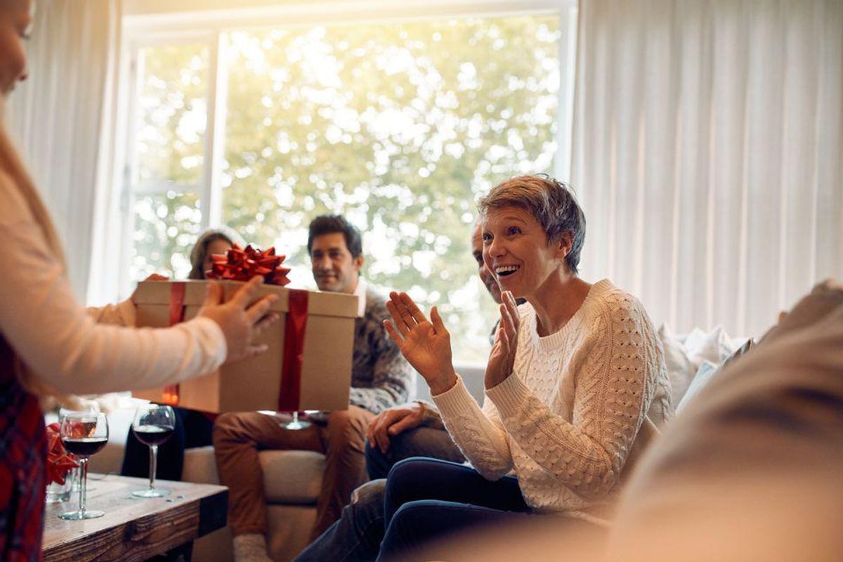 A child giving a parent a holiday present.