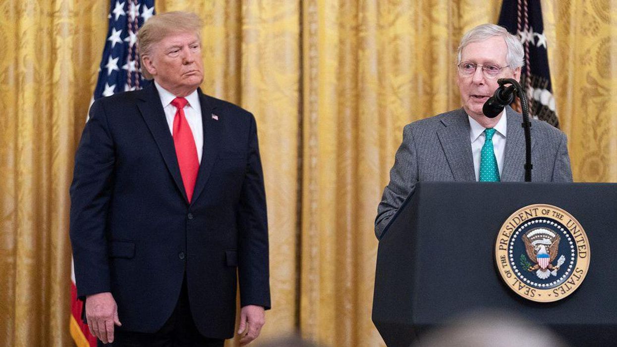 Former President Trump, left, watches Sen. Mitch McConnell speak in 2019.