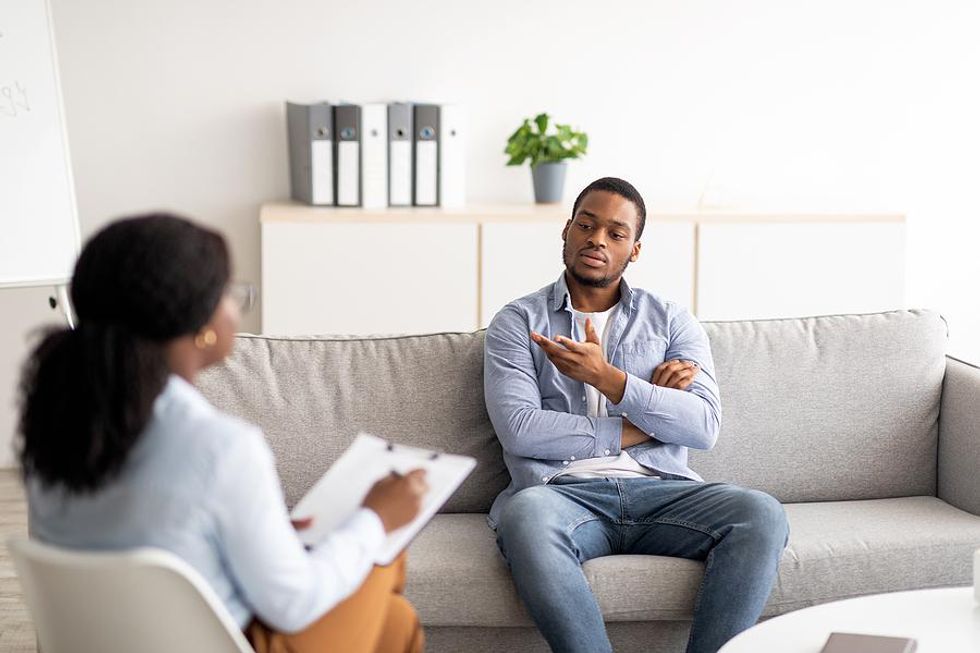 Burned out man talks to someone about his stress