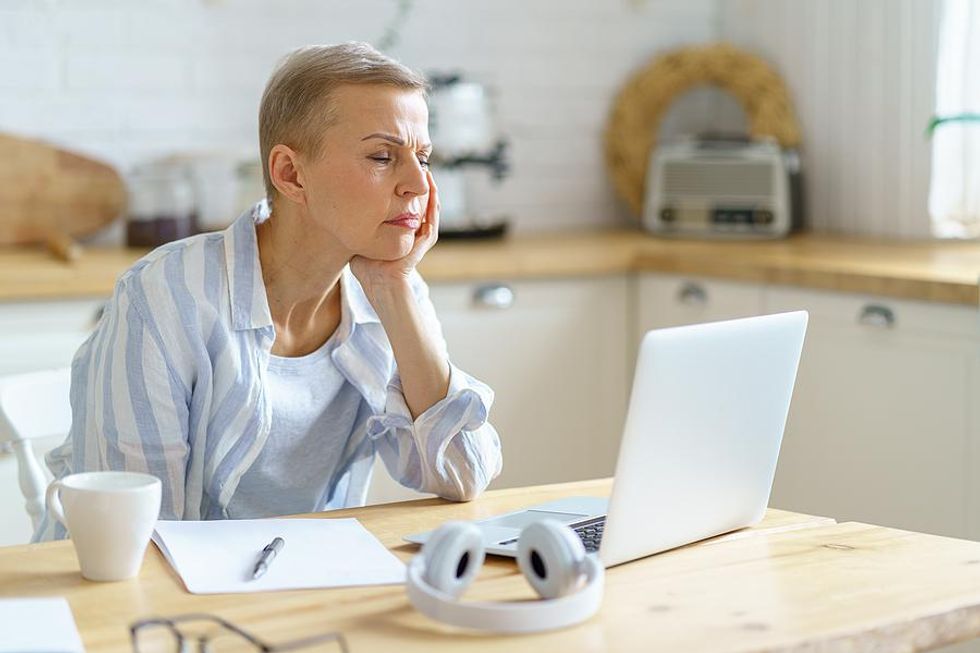 Burned out woman falling asleep as she works