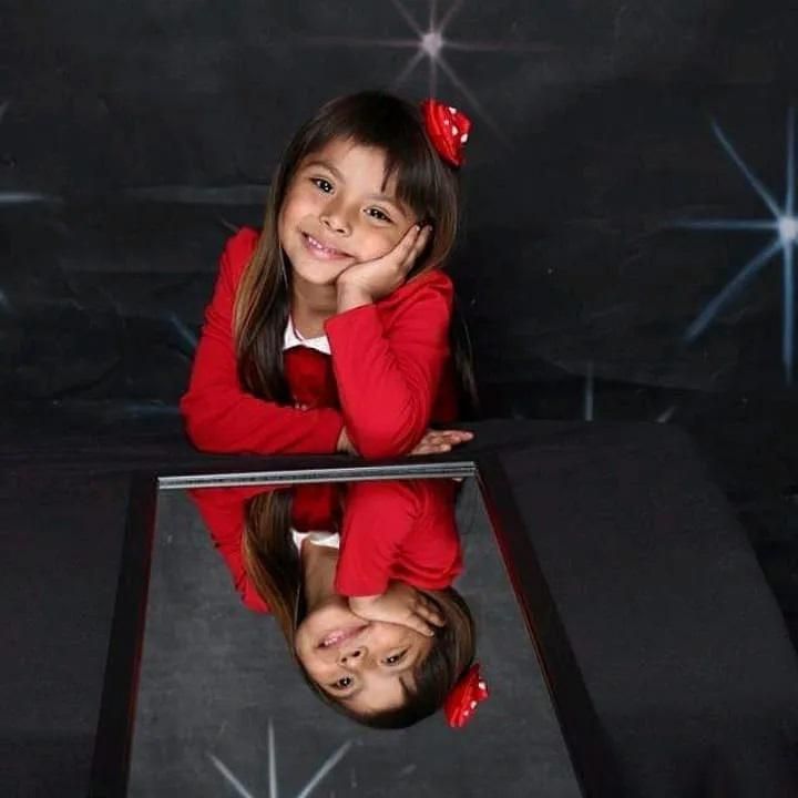 adhara dressed up and smiling with her mirror reflection